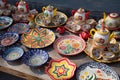 Sets of ceramic painted Uzbek tea ware with bowls and teapots and ceramic plates with national ornament. April 29, 2019