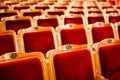 Sets on an empty theatre, taken with selective focus and shallow depth of field. Empty vintage red seats with numbers, teather cha Royalty Free Stock Photo