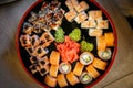 Sets of sushi nigiri, rolls and sashimi served in traditional Japan black Sushioke round plate Royalty Free Stock Photo