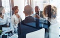 He sets the tone for a positive meeting. a team of professionals having a meeting in the boardroom at work.