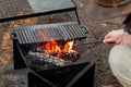Setting the campfire in a portable foladble firepit for a camp cooking