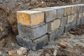 Setting concrete foundation blocks, forming the perimeter of a new building under construction Royalty Free Stock Photo