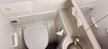 The setting features a clean restroom with a toilet and a small sink, designed for convenience on a train. The space is Royalty Free Stock Photo