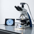 Setting features a compound microscope with binocular lenses atop Royalty Free Stock Photo