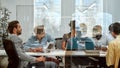 Setting Goals. Group of business people communicating and discussing fresh ideas while sitting together behind the glass