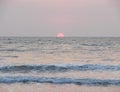 Setting Red Sun at Horizon over Sea at Payyambalam Beach, Kannur, Kerala, India Royalty Free Stock Photo