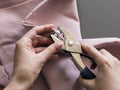 Setting a snap in pink french terry fabric with a piercing riveting tool Royalty Free Stock Photo