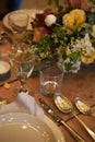 Setting a summer wedding dinner table in a rustic style