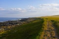 The setting sun casts long shadows over a Northumbrian beach Royalty Free Stock Photo