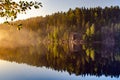 setting sun illuminating the rocks over a calm lake Royalty Free Stock Photo