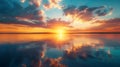 Setting sun over calm ocean creates fiery reflection Royalty Free Stock Photo