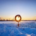the setting sun over the frozen river and the steam from the water in severe frost Royalty Free Stock Photo