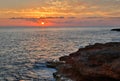 Setting sun over the sea and rocks Royalty Free Stock Photo
