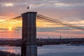 The setting sun paints a colorful sky behind the Brooklyn Bridge in New York City NYC Royalty Free Stock Photo