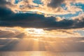 Setting sun rays beaming through beautiful clouds. Royalty Free Stock Photo