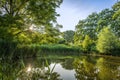 The setting sun is reflected in this pond in De Wijdse Weide park in Zoetermeer Royalty Free Stock Photo