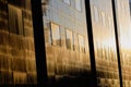Setting sun is reflected in the windows of a tall glass office building in the old center of Bucharest Royalty Free Stock Photo