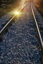 Setting sun and reflection on rails Royalty Free Stock Photo