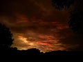 The setting sun shines light on the clouds so that they look a very beautiful orange color Royalty Free Stock Photo