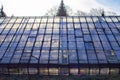 The setting sun shines over the glass roof of the greenhouse Royalty Free Stock Photo