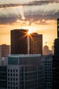 Setting sun shines at the top of a building in the San Francisco skyline at sunset