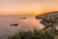 The setting sun sinks behind a headland and illuminates the landscape at Ulcinj, Montenegro