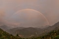 The setting sun and the sky appear Primary and Secondary Rainbow