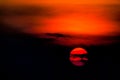 Setting sun sunset colors wave in red orange contrast dark black sky nature amazing background