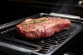 setting a trimmed ribeye steak on a grill pan Royalty Free Stock Photo