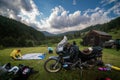 Setting up a blue tent with a great view of the mountains. A trip on a motorbike. A touring motorcycle with lots of gear. Bags,