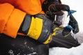 Setting up ski equipment, close-up of a hand for setting up and twisting ski boot bindings on a mountain in the snow Royalty Free Stock Photo