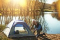 Setting up their shelter. a senior couple setting up a tent while camping in the wilderness.