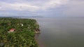 Settlement houses and establishments along tropical sandy Beach and Beautiful Calm Sea On Cloudy Day