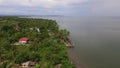 Settlement houses and establishments along tropical sandy Beach and Beautiful Calm Sea On Cloudy Day