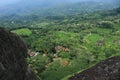 settlements of residents who are under a stone mountain that is lush green