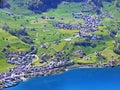 The settlements of Unterterzen and Quarten over the shores of Lake Walensee and under the slopes of the Glarus Alps