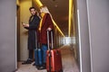 Settling in the room. Young couple near the hotel room together Royalty Free Stock Photo