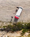 Setubal, Portugal - 27 march 2021: Aerial view of a red and white motor home parked on the beach in nature, Setubal, Portugal