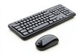 This setup features a sleek black keyboard and mouse positioned neatly on a clean white surface, ideal for office or Royalty Free Stock Photo