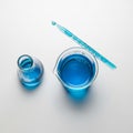Setup featuring a beaker and flask, both filled with a vibrant blue Royalty Free Stock Photo