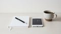 Setup featuring a white notebook with a black pen a smartphone Royalty Free Stock Photo