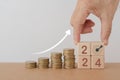 Setup objective target business cost and budget planing of new year concept. Hand arranged wooden cube block with 2024 ,