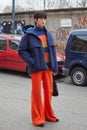 SeungChan with blue waterproof jacket and orange trousers before K-Way fashion show, Milan