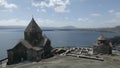 Sevan Monastery. Buildings, Lake Sevan, mountains, rocks, grass, sky, people Royalty Free Stock Photo