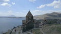 Sevan Monastery. Buildings, Lake Sevan, mountains, rocks, grass, sky, people Royalty Free Stock Photo
