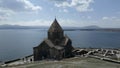 Sevan Monastery. Buildings, Lake Sevan, mountains, rocks, grass, sky, people Royalty Free Stock Photo