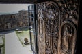 The temple complex of an ancient Christian monastery and decorative doors with bas-reliefs depicting saints Royalty Free Stock Photo