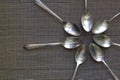 Seven Antique Silver Spoons in a Circle on a Scree