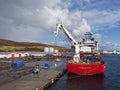 The Seven Atlantic Offshore Supply Vessel unloading shipments with its own Crane on to Peterson Quay .