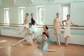 The seven ballerinas at ballet bar